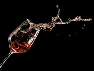 Rose wine splash on black background - 596099616