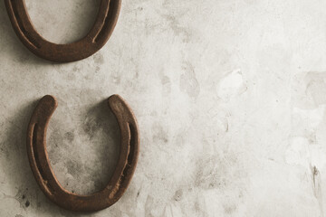 Western background for equine industry with copy space beside old rusty horse shoes.