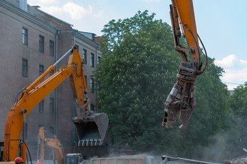 Demolition of building. Excavator breaks old house. Freeing up space for construction of new...