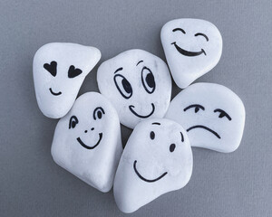 Emotion management concept, stones with painted faces symbolize different emotions. We are all...
