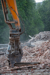 Demolition of building. Excavator breaks old house. Freeing up space for construction of new building