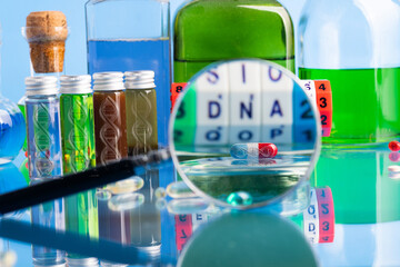 pill and vials of DNA on the background of a laboratory table with medicines and preparations. View...