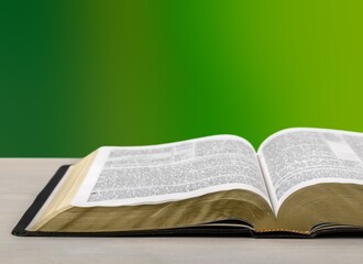 Open Bible book on wooden table