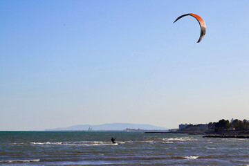 Kitesurfer flying over the waves in Ebro river delta national park, one of the most amazing spots...