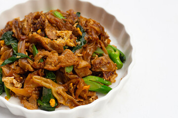 Stir-fried rice noodles with soy sauce and pork