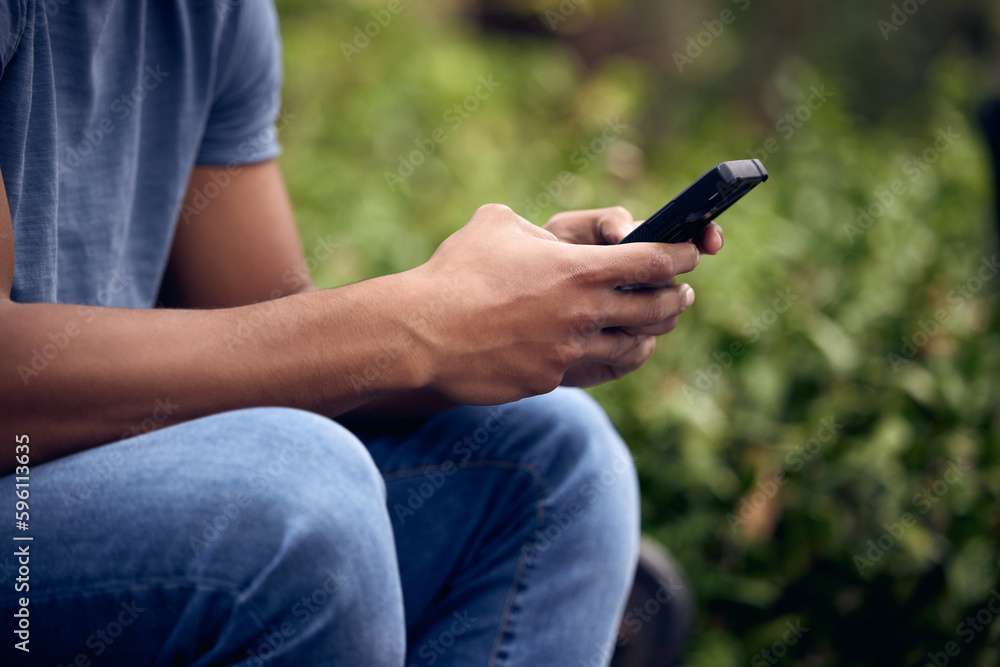 Poster Spending time with nature, be right back. an unrecognisable man using a smartphone while taking a break in a park.
