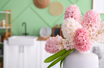 Vase with beautiful hyacinth flowers in kitchen, closeup © Pixel-Shot