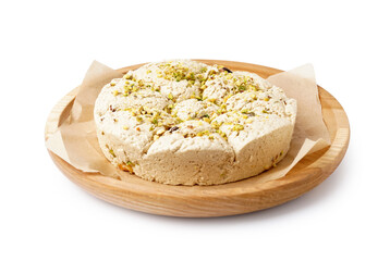 Plate of tasty Tahini halva with pistachios on white background