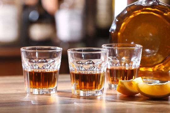 Glasses of cold rum on table in bar