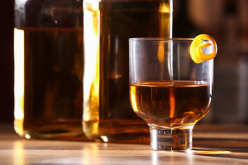 Glass of cold rum on table in bar
