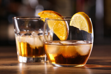 Glasses of cold rum on table in bar, closeup