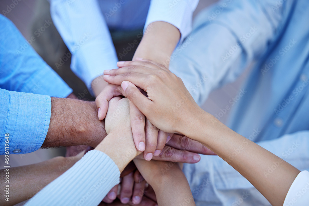 Poster all in. high angle shot of a group of unrecognizable businesspeople standing outside with their hand