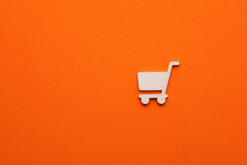 white supermarket car icon on orange color background - Supermarket concept, graphic resource for...