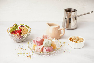 Bowls with tasty Turkish delight on light background