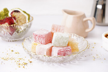 Bowl with tasty Turkish delight on light background