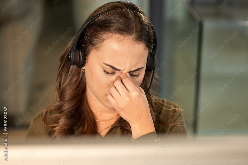 Poster i give up. a young call centre agent looking stressed out while working in an office.