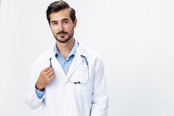 Man doctor in a white coat with a stethoscope smile with teeth and good test results looking into the camera on a white isolated background, copy space, space for text, health