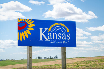 Kansas welcomes you - welcome roadside sign with a popular Latin phrase ad astra per aspera...