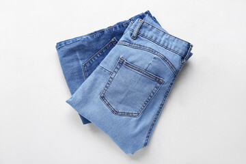 Stylish jeans on white background