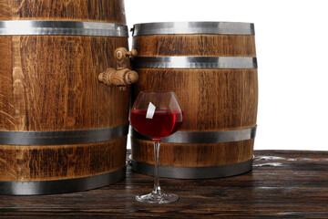 Naklejka na ściany i meble Wooden barrels and glass of wine on table against white background