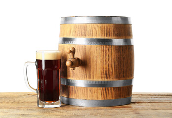 Wooden barrel and mug of cold beer on table against white background