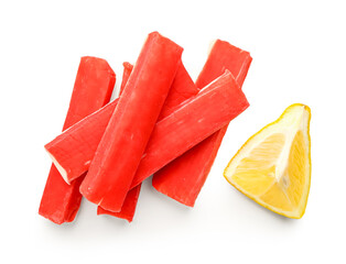 Tasty crab sticks with piece of lemon on white background © Pixel-Shot