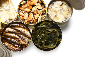 Opened tin cans with different seafood isolated on white background
