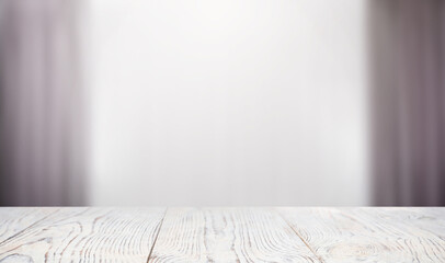 Empty white wooden table against window with curtains. Space for design