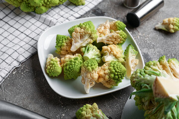 Plate with romanesco cabbage on grey grunge background