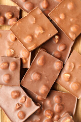 Sweet tasty chocolate with nuts as background