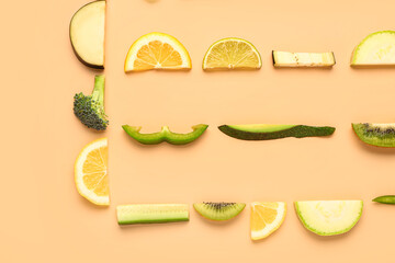 Composition with green fresh fruits and vegetables on orange background