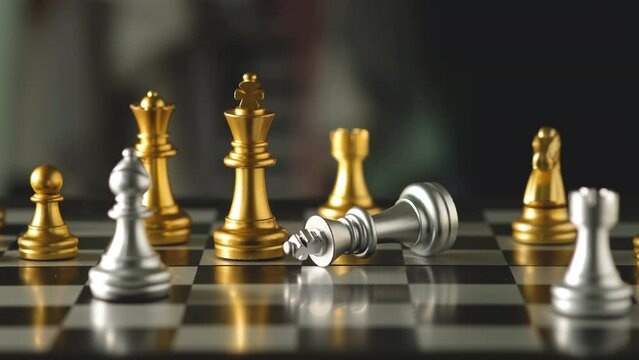 Golden chess over silver chess on board, strategy game concept for victory
