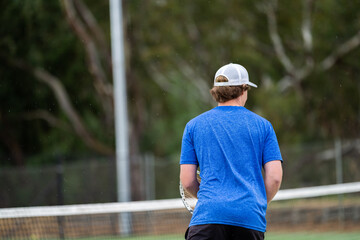 Amateur playing tennis at a tournament and match on grass in Europe 