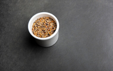 Close up of steak spices on black cutting board.
