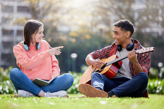 You know its love when he writes a song about you. a young man and woman playing the guitar on a study break at college. - Powered by Adobe