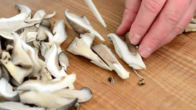 We cut mushrooms. Oyster mushroom mushrooms on a board.