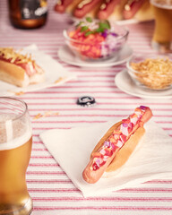 Served table with hotdogs and beer