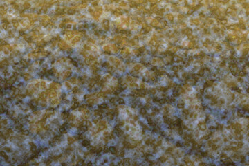 Abstract background of natural stone under water with spots of light, shadows and splashes.