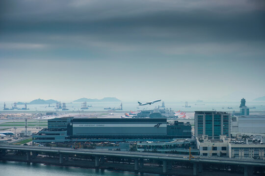 International airport with airplane takeoff and aviation, terminal building and transport cargo port in overcast day