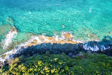 Beautiful turquoise sea and wave crashing on coastline in summer