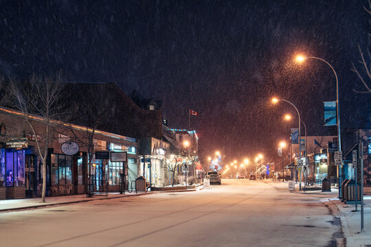 Beautiful Jasper town with snowfall and street light in downtown at night