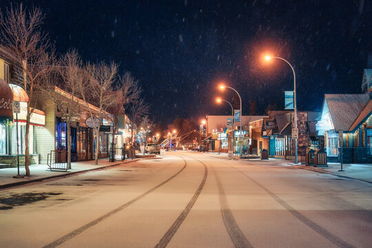 Beautiful Jasper town with snowfall and street light in downtown at night