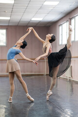 Fototapeta na wymiar Two Asian ballerinas are dancing in the class. 