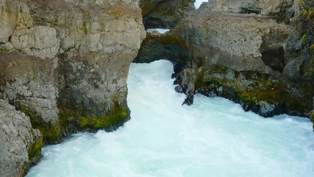 Canyon river with pure turquoise glacial water. Unusual mountain landscape in Iceland. Shot in 8K Resolution 4320p