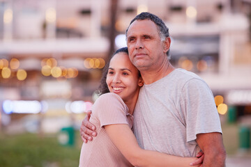 Our favourite part of our day is watching the sunset. an attractive young woman standing with her father and watching the sunset on the beach.