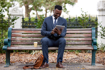 Fototapeta premium Take a break to clear your mind. a young businessman using a digital tablet in the city.