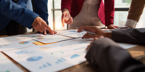 Close up of Diverse colleagues gather brainstorm discuss financial statistics at office meeting. finance, teamwork, Big data Graphs Charts concept