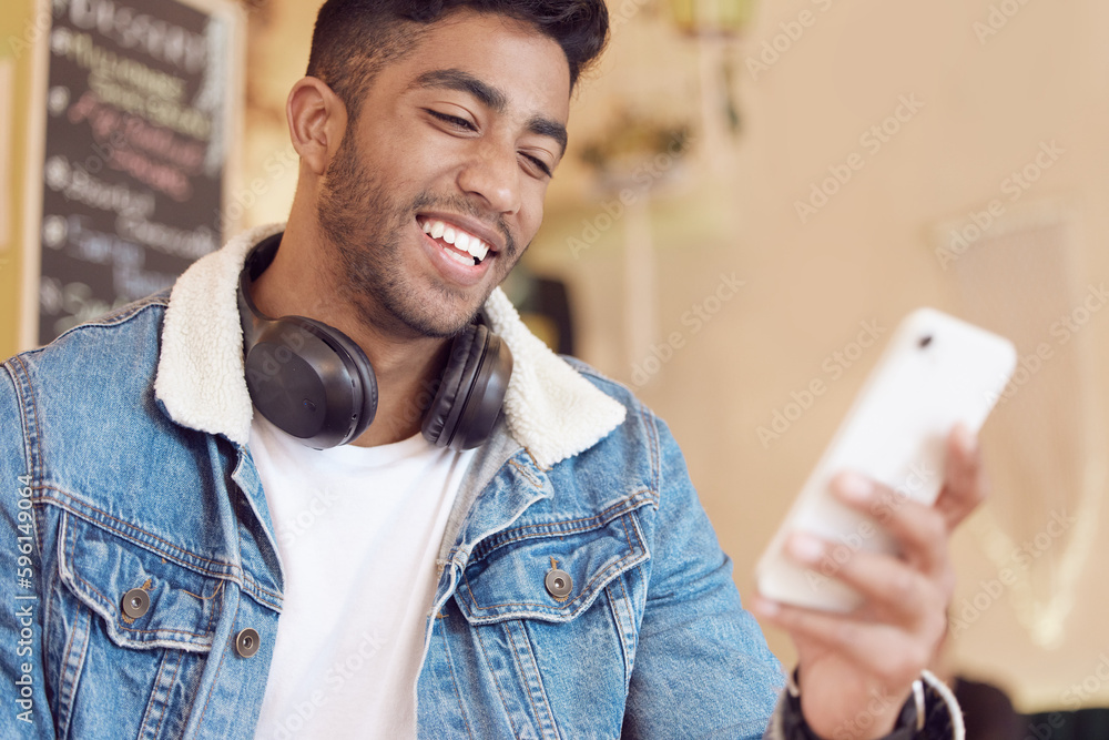 Poster you make me smile. a young man using his smartphone to send a text message.