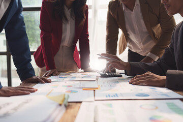 Close up of Diverse colleagues gather brainstorm discuss financial statistics at office meeting....