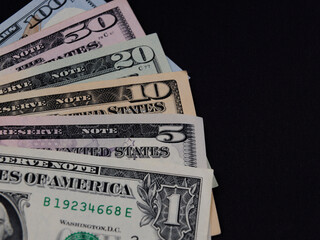 US dollar banknotes on black background